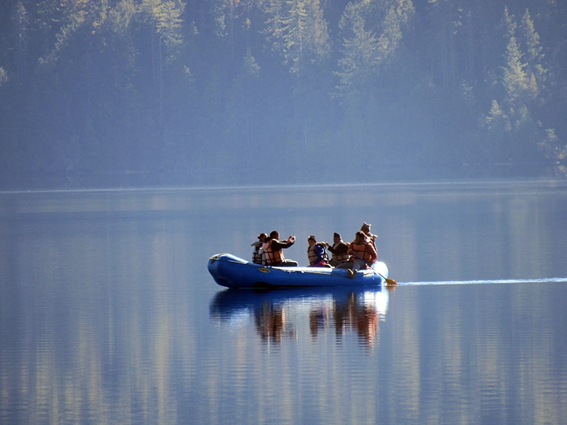 Tourists boating on the serene, turquoise waters of Rara Lake, a popular activity